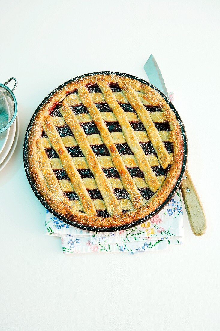 A whole Linzertorte (nut and jam layer cake) in a baking tin