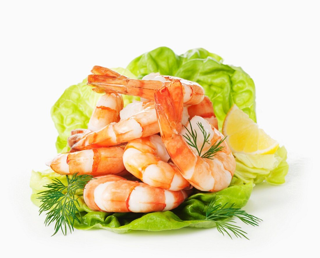 Cooked prawns on lettuce with dill and lemon