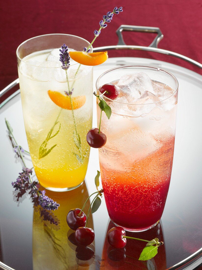 Two fruity drinks on a glass tray