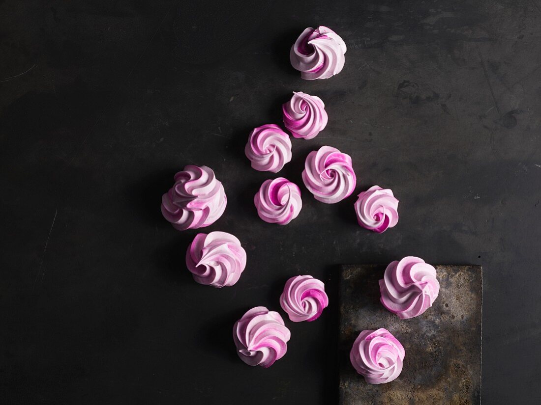 Pink meringues on grey surface