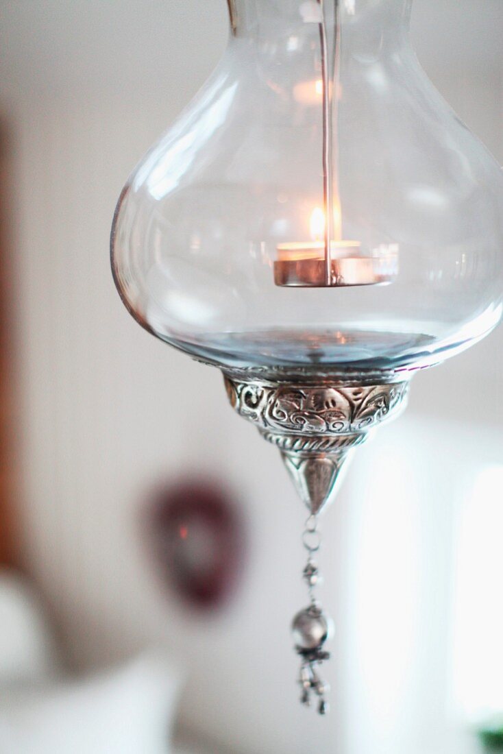 Suspended glass candle lantern with silver ornamentation