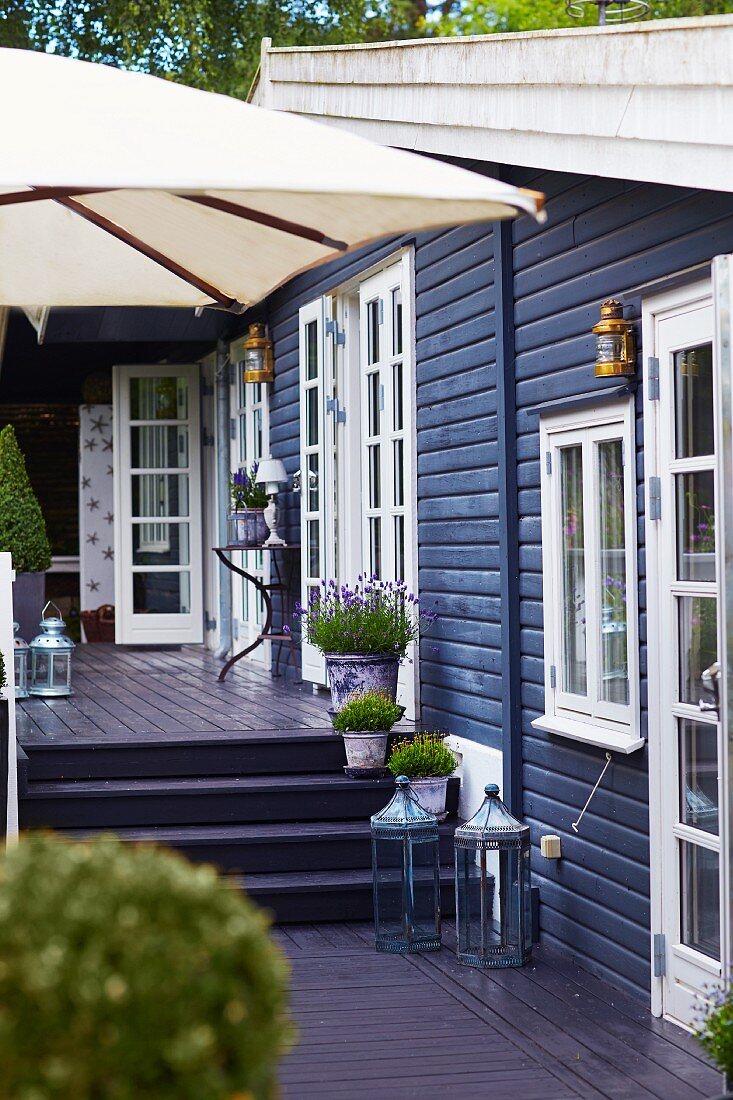 Split-level terrace adjoining wooden house with white lattice windows