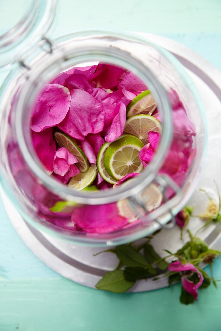 Rose petals for rosewater in a glass container (seen from above)