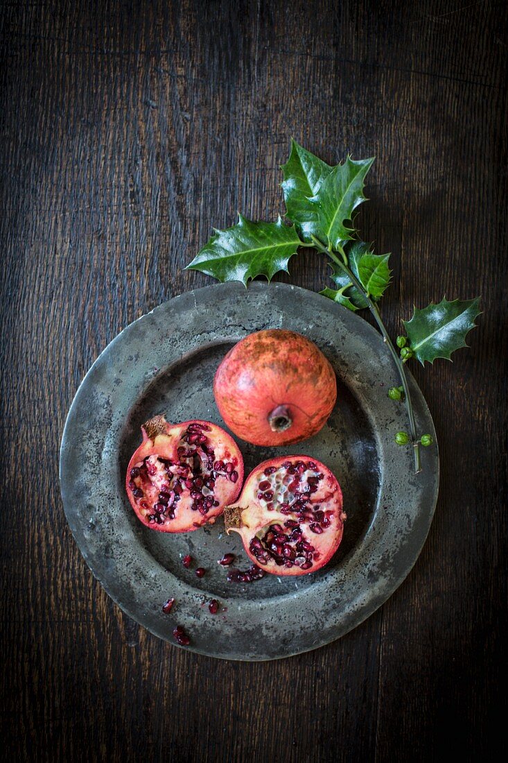 Pomegranates and a sprig of holly