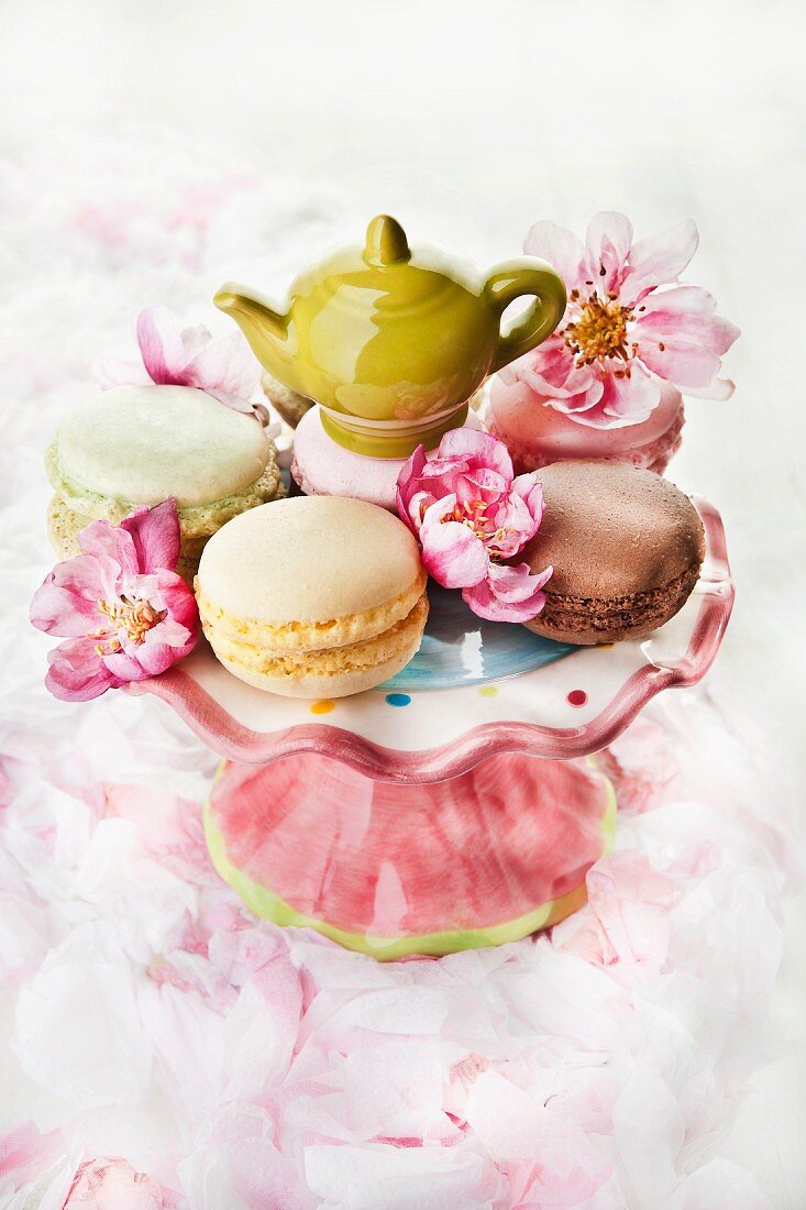 Macaroons on a cake stand with a mini teapot