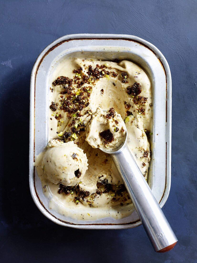 Homemade ice cream in a container with an ice cream scoop