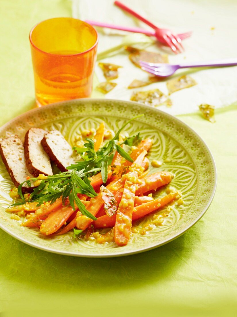 A carrot medley with ginger and chilli served with tofu slices and rocket