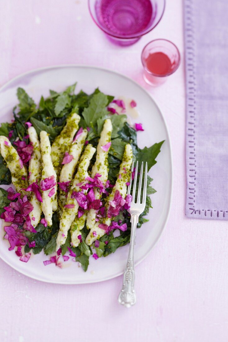 Pistachio potato orzo pasta on a wild herb salad