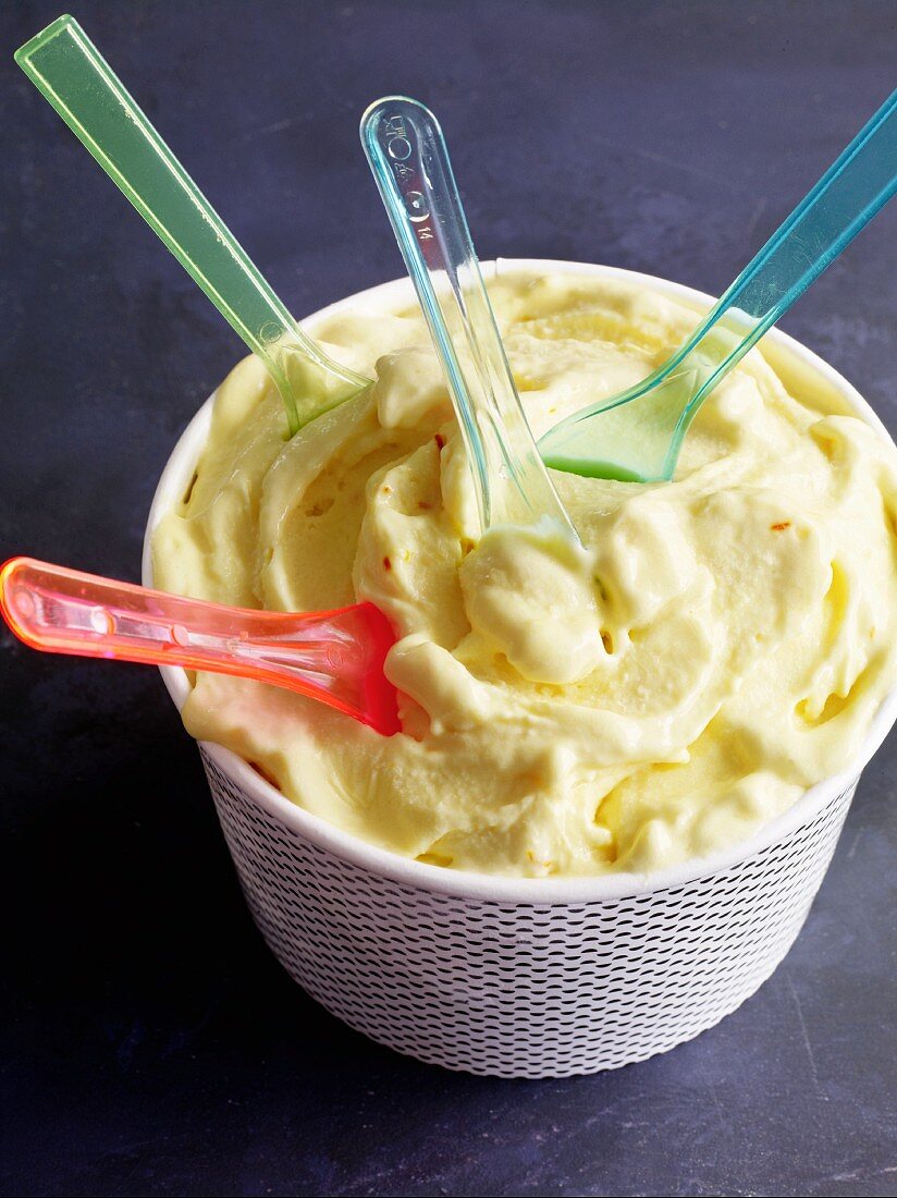 A cup of frozen yoghurt with mango and saffron