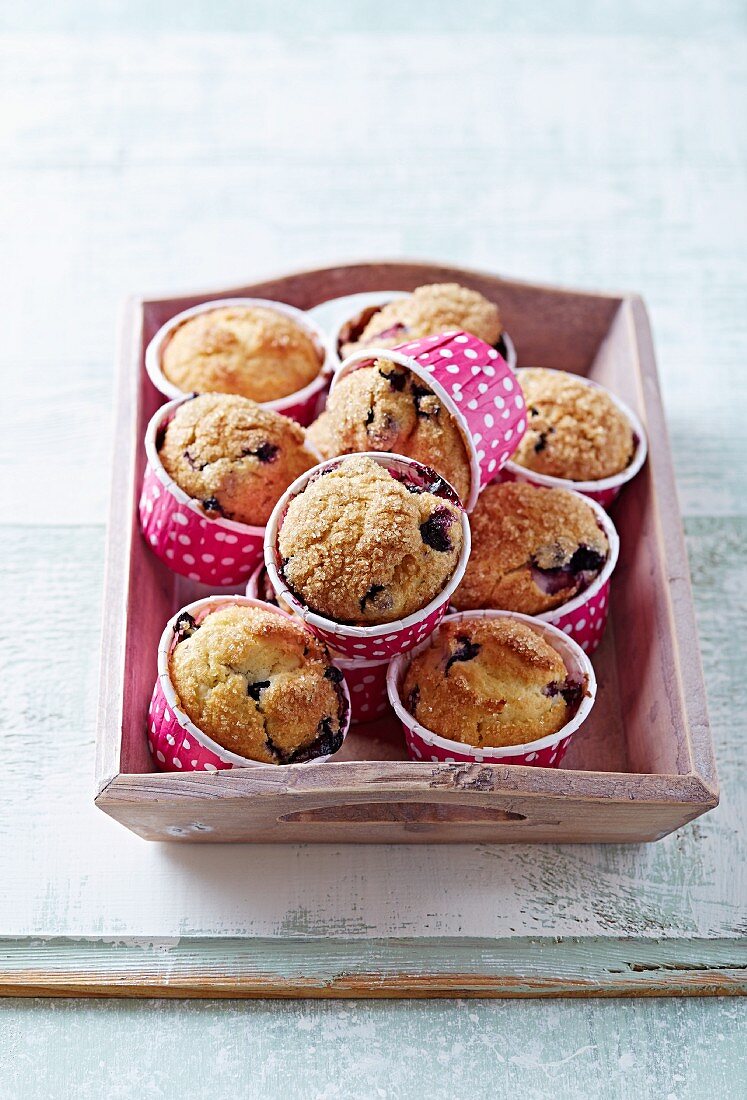 Blueberry muffins with brown sugar on a wooden tray