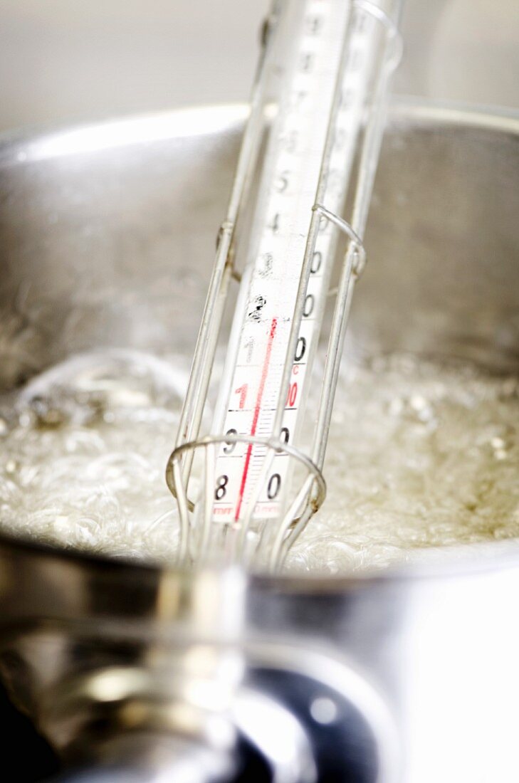 Sugar syrup being boiled with a sugar thermometer