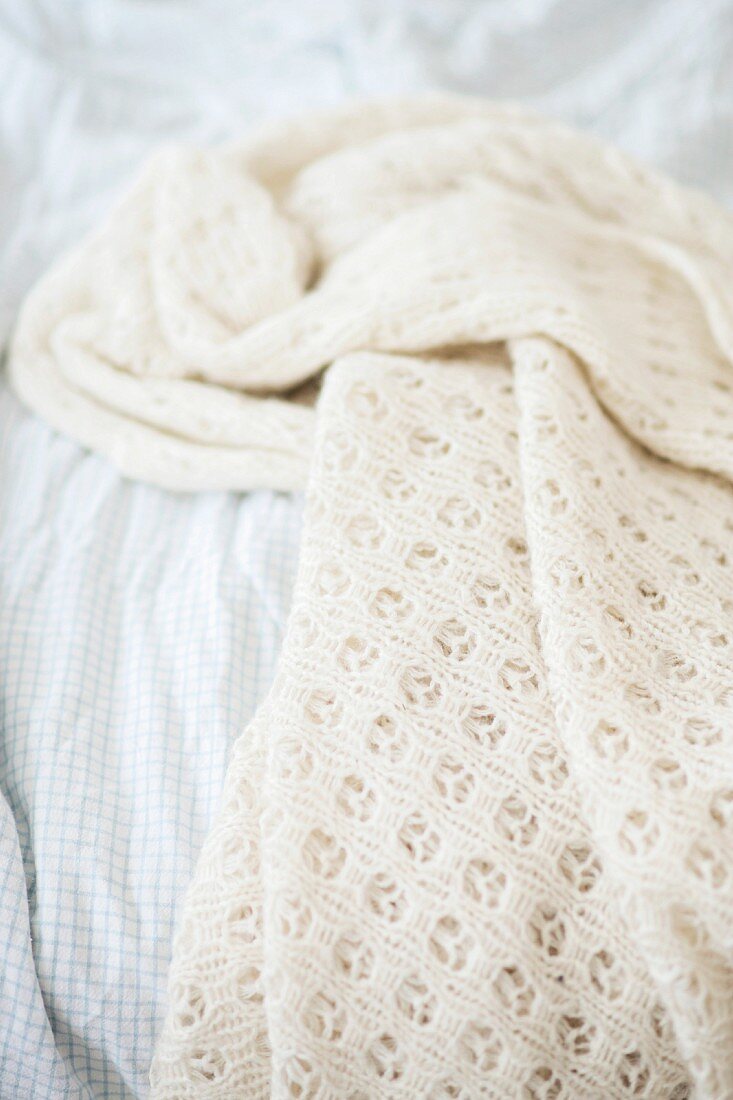 White knitted blanket on bed