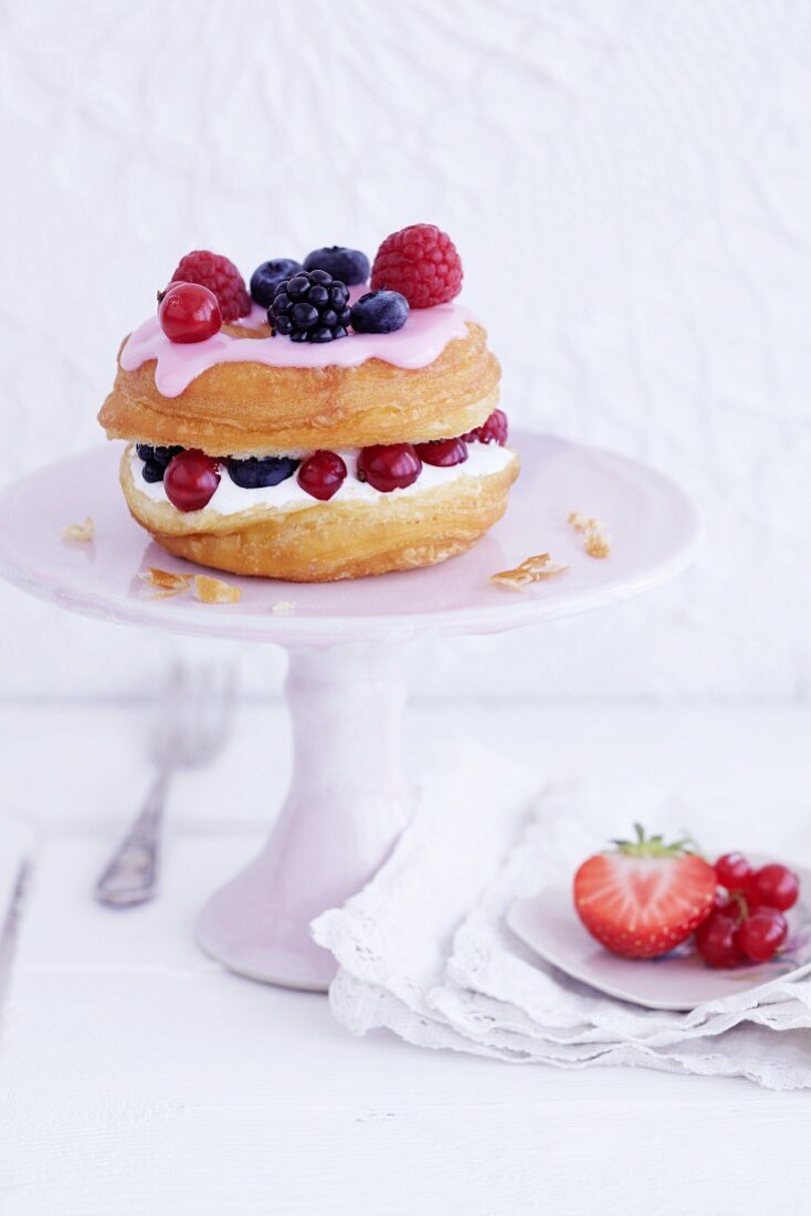 A croissant-doughnut with marshmallow cream and berries