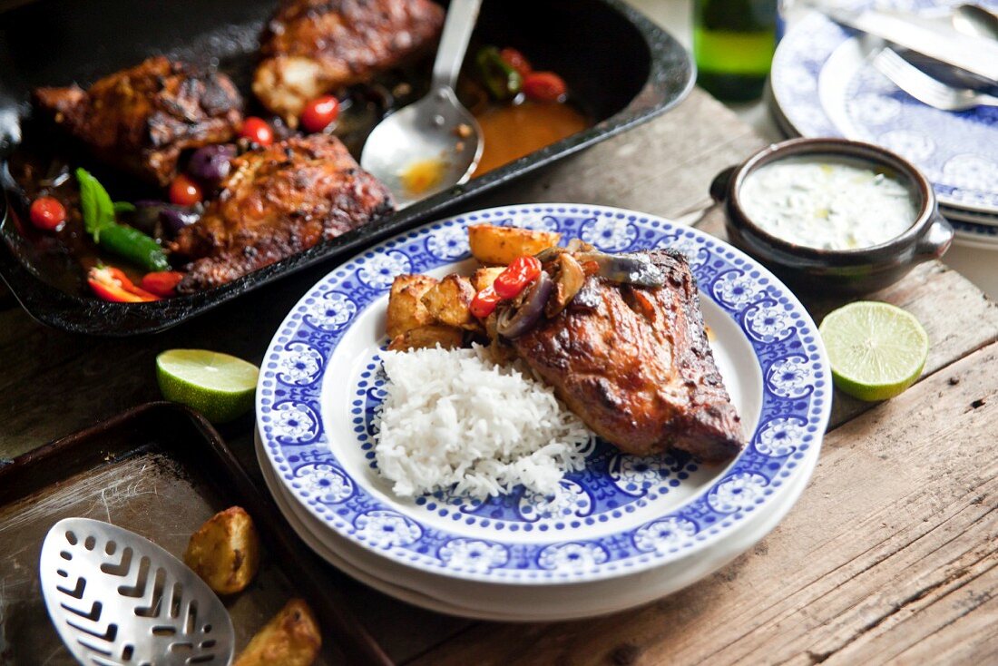 Tandoori chicken legs with basmati rice, potatoes and raita