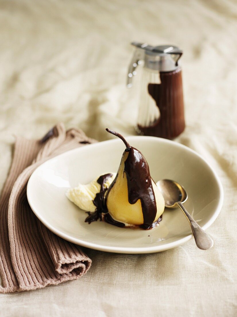 Poached Pear with Chocolate Sauce and a Scoop of Vanilla Ice Cream, Spoon