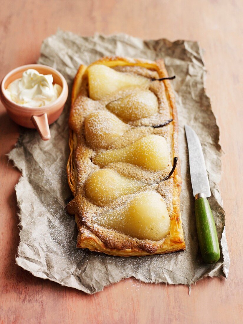 Pear and almond tart with icing sugar