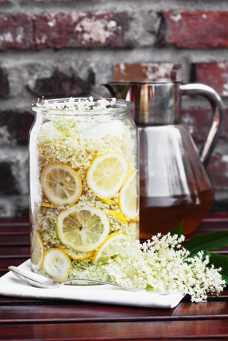 Homemade elderflower syrup in a large jar