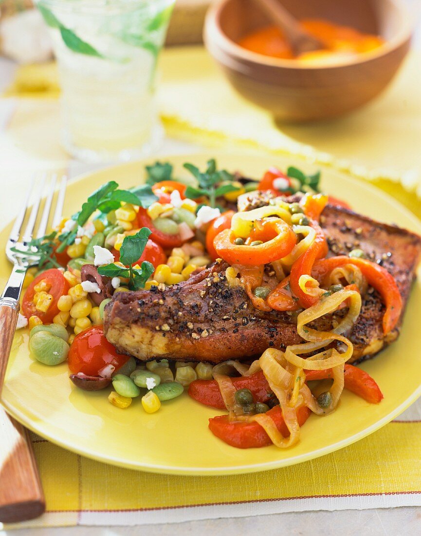 Pork chop with a sweetcorn salad and peppers