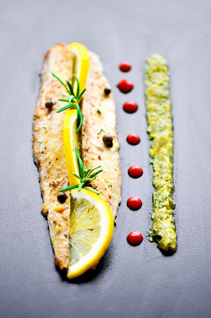 Grilled mackerel fillet with lemon, rosemary, salsa verde and pomegranate syrup