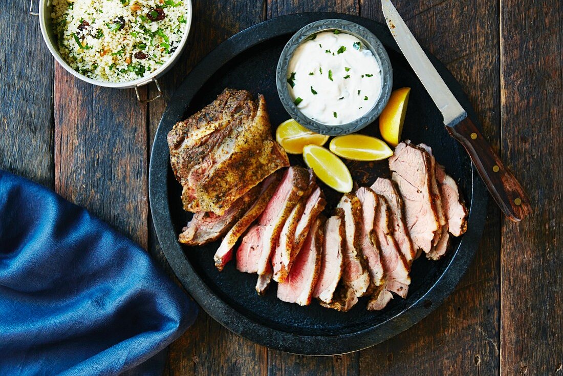 Sliced shoulder of lamb with customers and tzatziki (Greece)