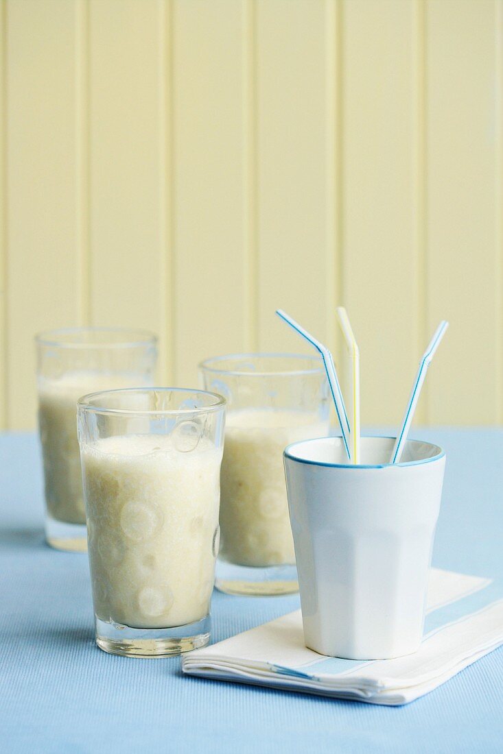 Banana smoothies and a cup of straws