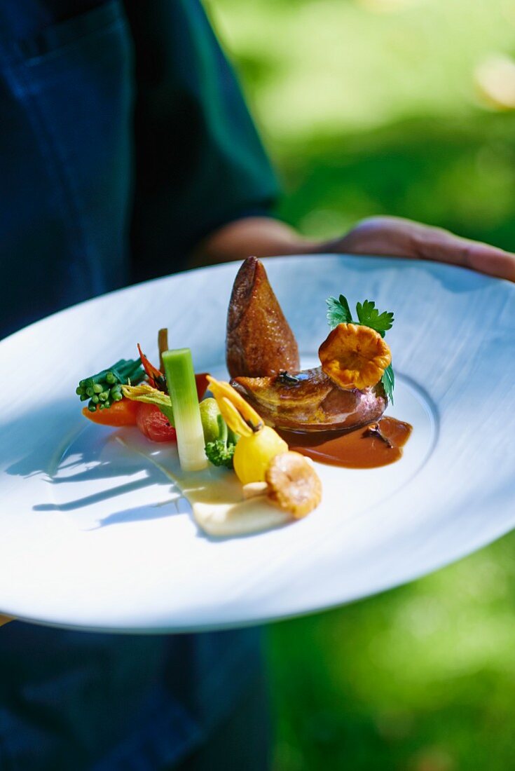 Pigeon breast with a side of vegetables