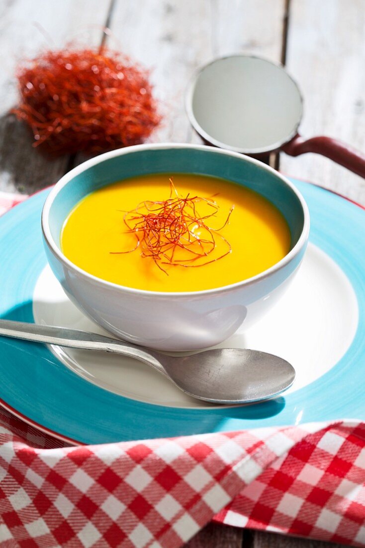 Hokkaido pumpkin soup with chilli threads in a soup bowl