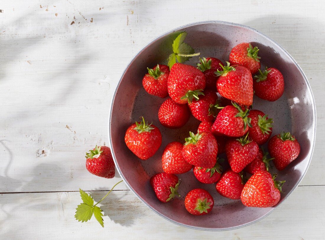 Strawberries in a metal bowl, seen from above