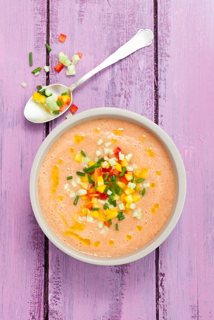 Creamy gazpacho with colourful diced vegetables and olive oil