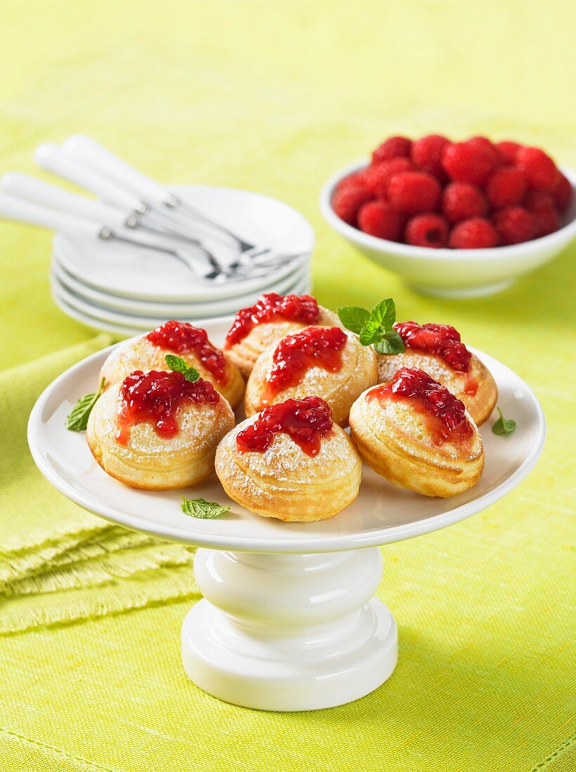 Sponge cakes with raspberry sauce on a cake stand