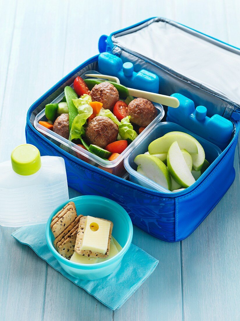 Meatballs, fruit and crackers for a picnic