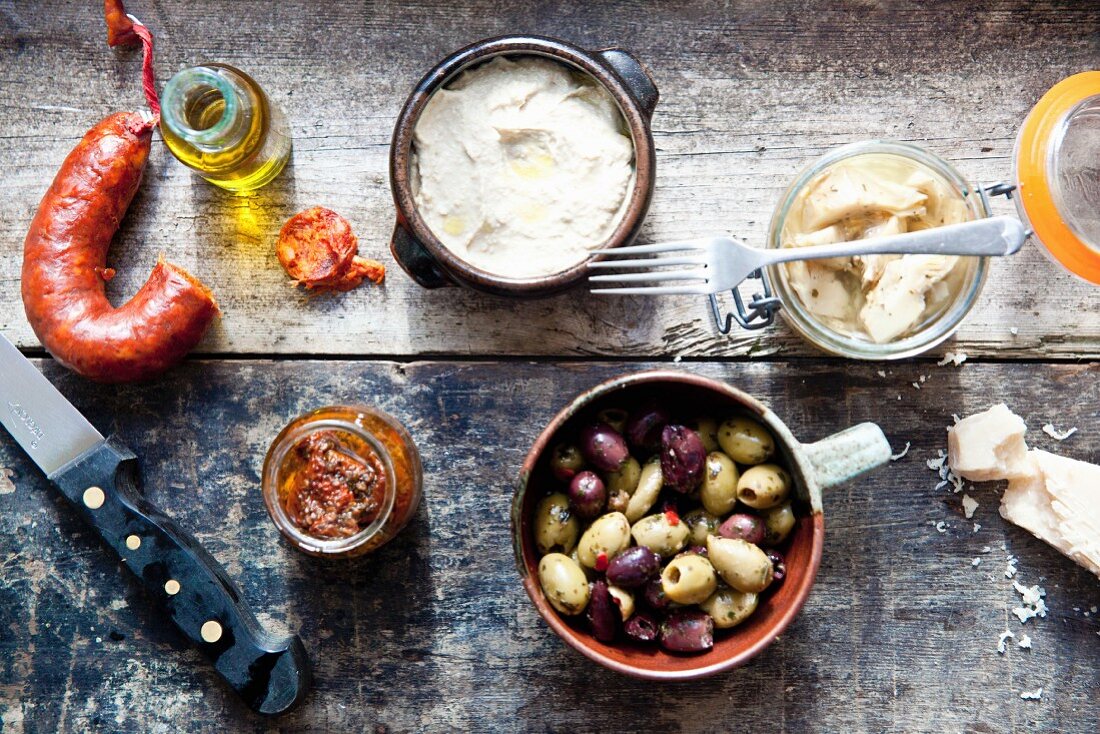 Various antipasti on a wooden surface