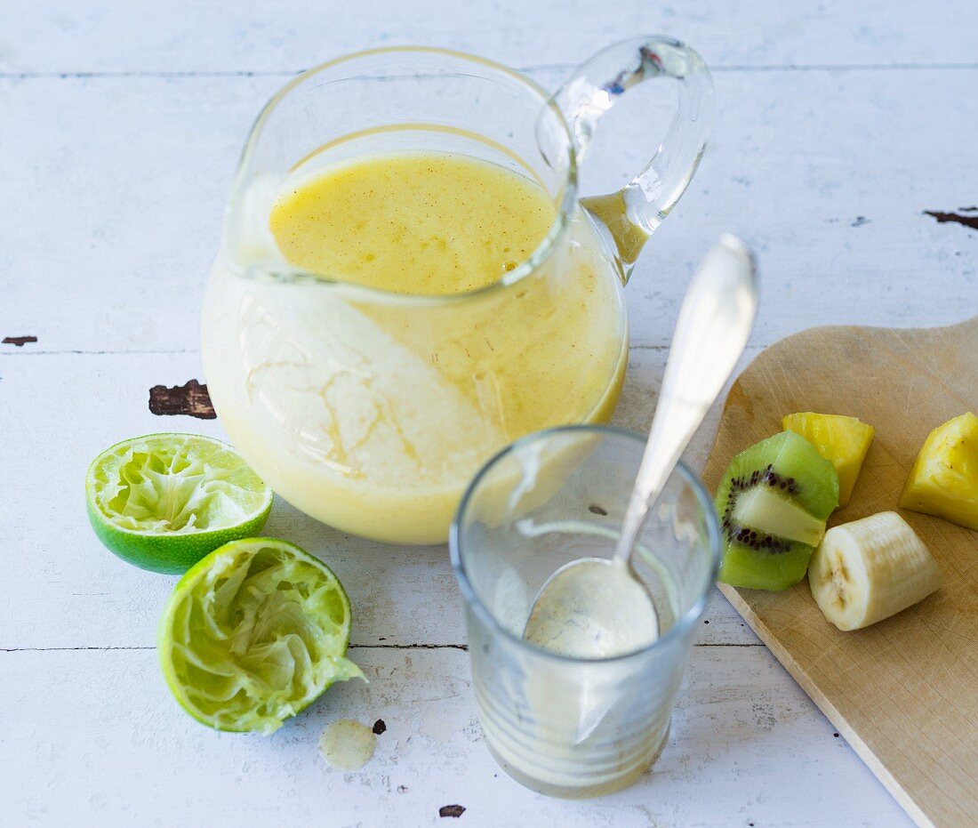 A pineapple and kiwi smoothie made with banana and lime juice