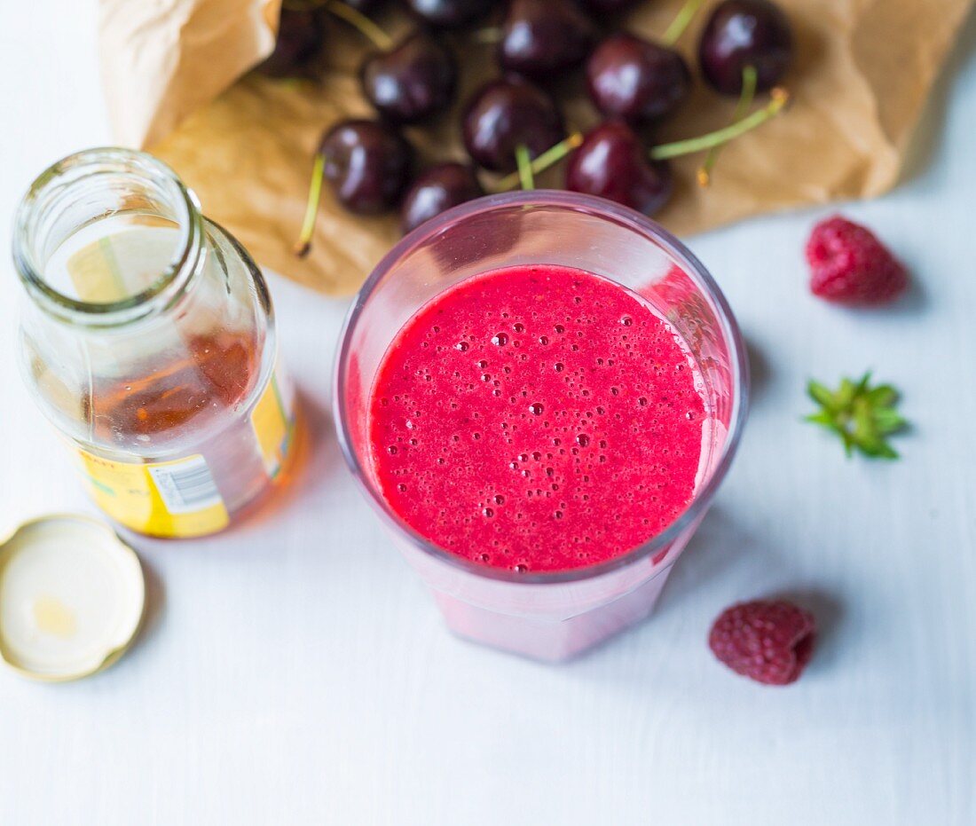 An almond milk smoothie made with cherries, berries and agave syrup