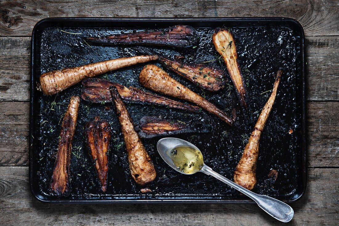 Roasted parsnips on a baking tray
