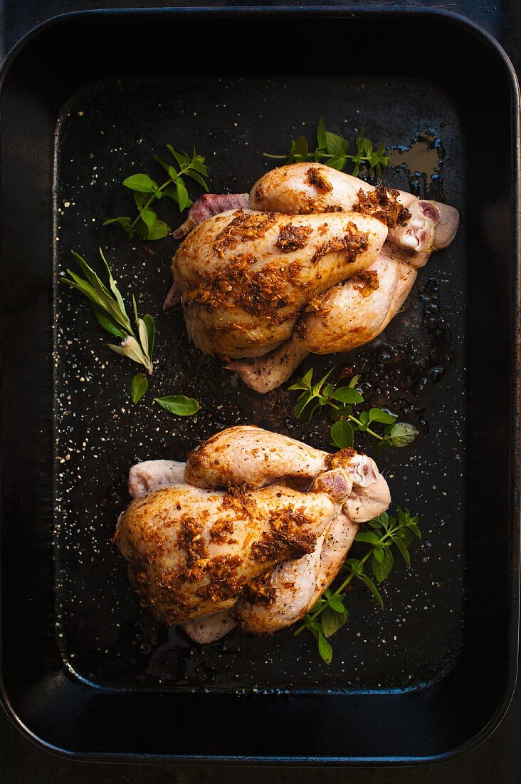 Spiced chickens in a roasting tin
