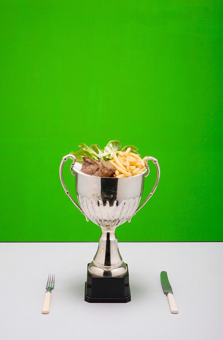 Beef with French fries in a trophy