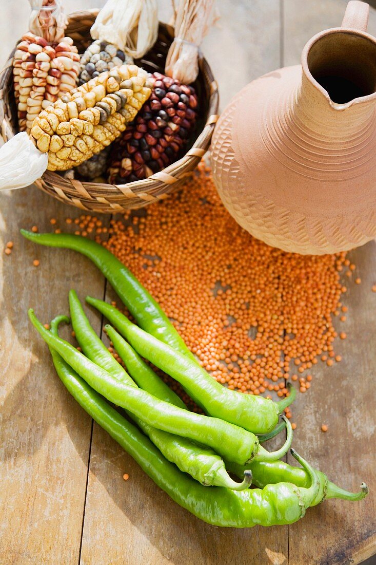 Dried corn cobs, lentils, chilli peppers and a jug