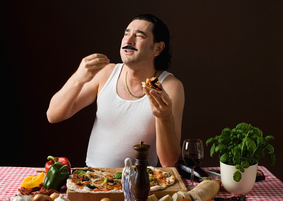 A stereotypical Italian man eating pizza