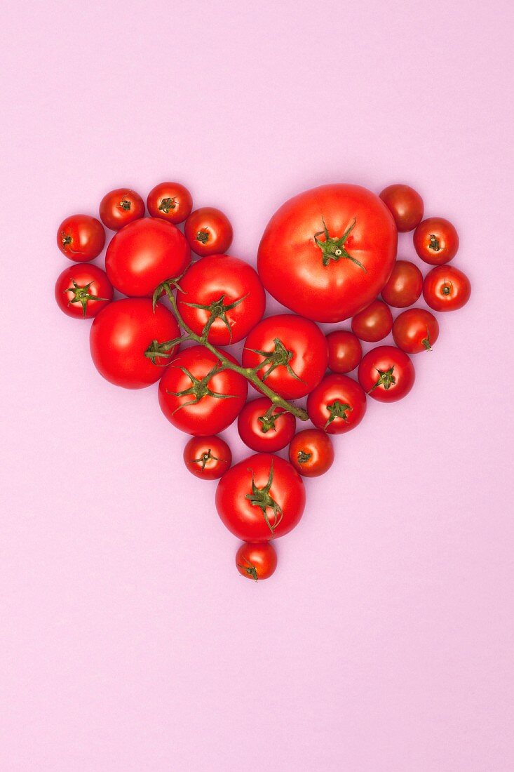 Various tomatoes arranged in the shape of a heart