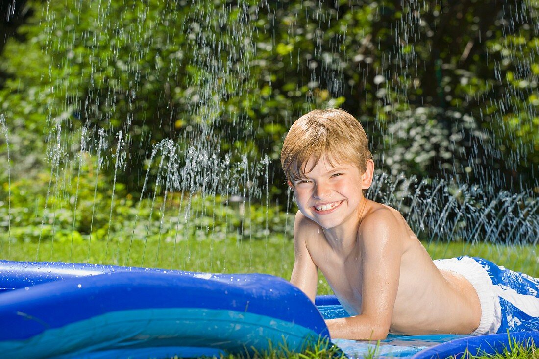 A boy lying on a water slide