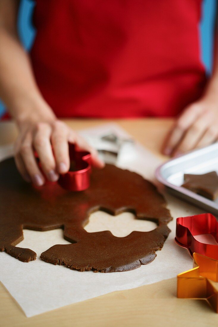 Gingerbread biscuits being cut out