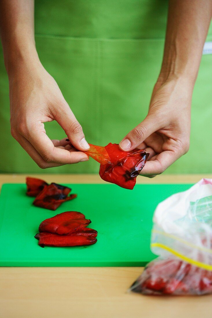 Roasted peppers being skinned