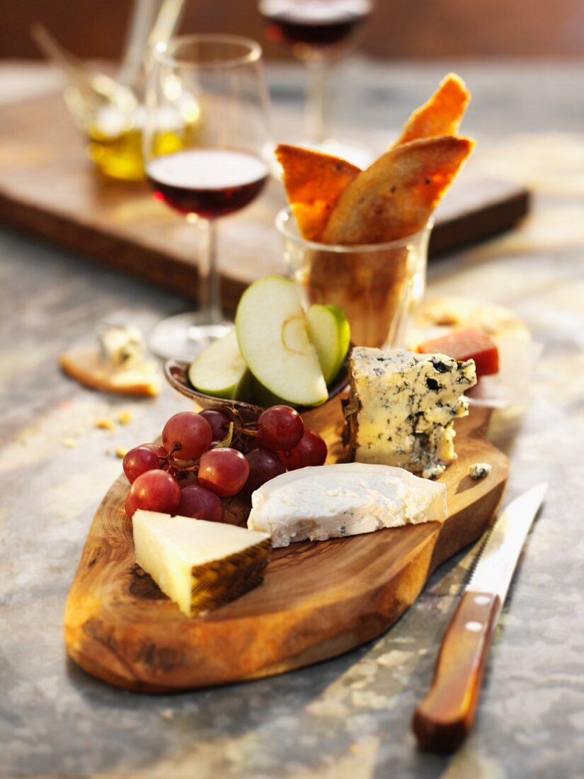 Assorted Cheese with Grapes on Bamboo Board
