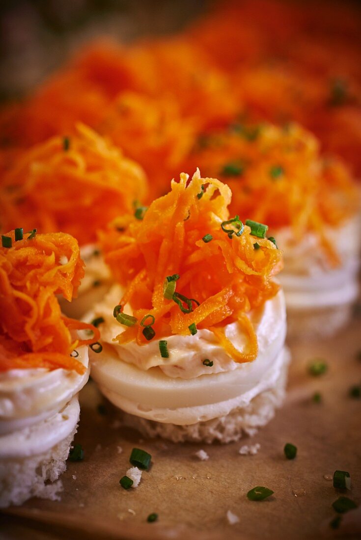 Spicy canapés made with bread, egg, mayonnaise cream and carrots