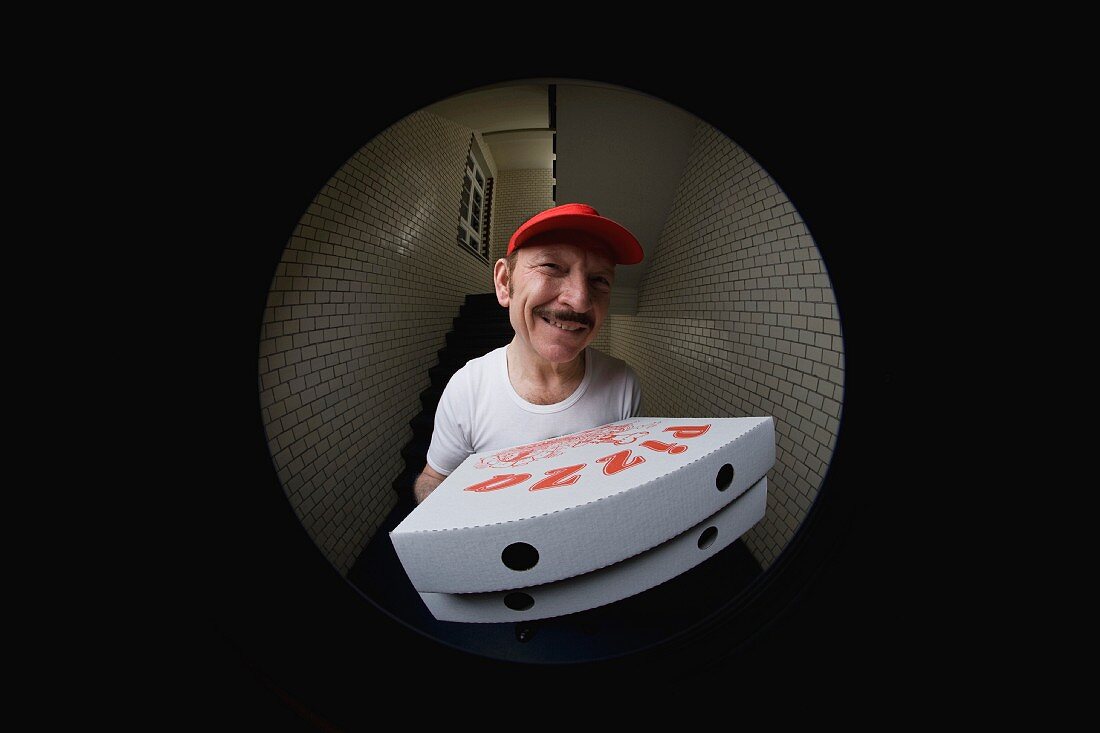 Pizzabote mit Pizzakarton im Türspion