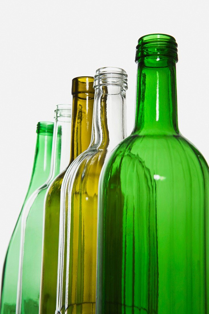 A row of different coloured glass bottles