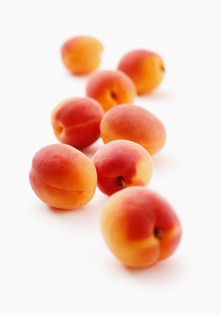 Apricots on a white surface