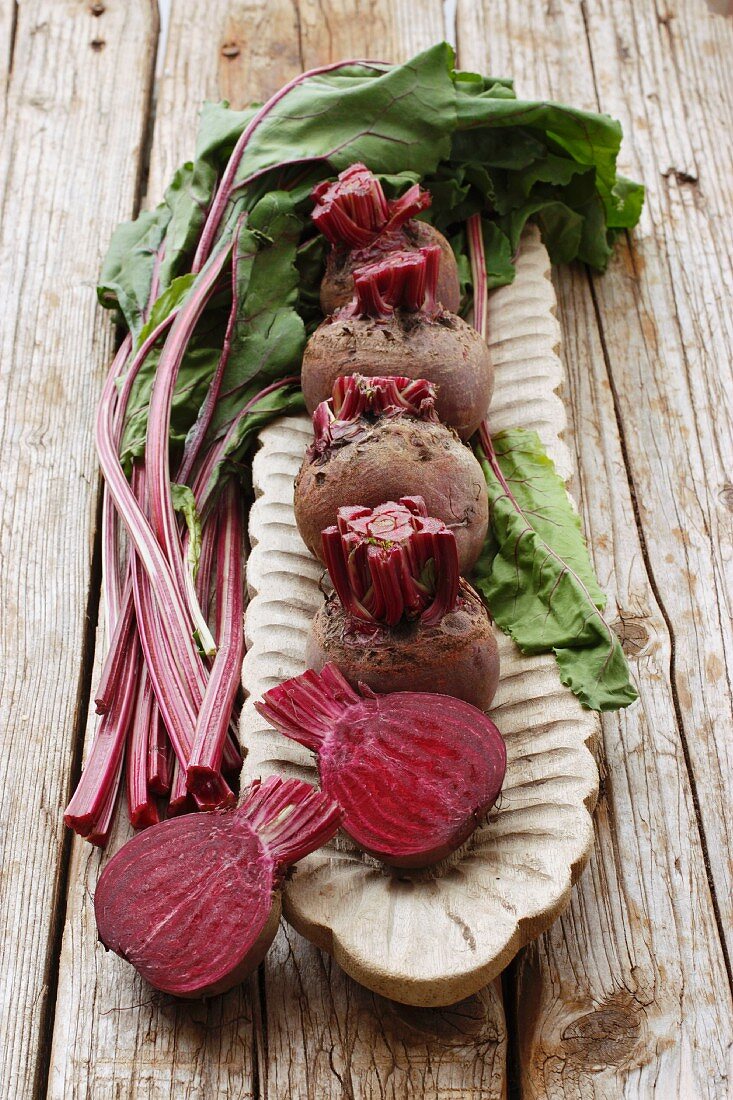 Beetroots, or whole and halved, in a long wooden dish