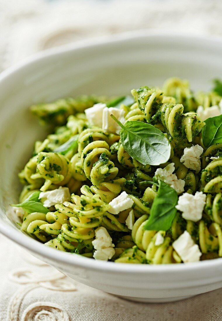 Fusilli in salsa verde, goat's cheese and basil (close-up)